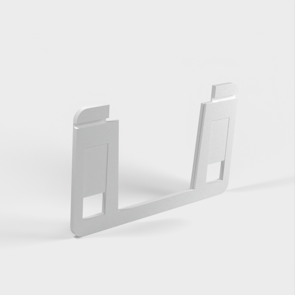 Kelluva tabletin seinäteline, jossa lataustuki