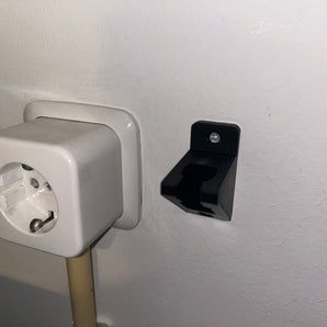 Seinäkiinnitteinen virtakaapelin pidike