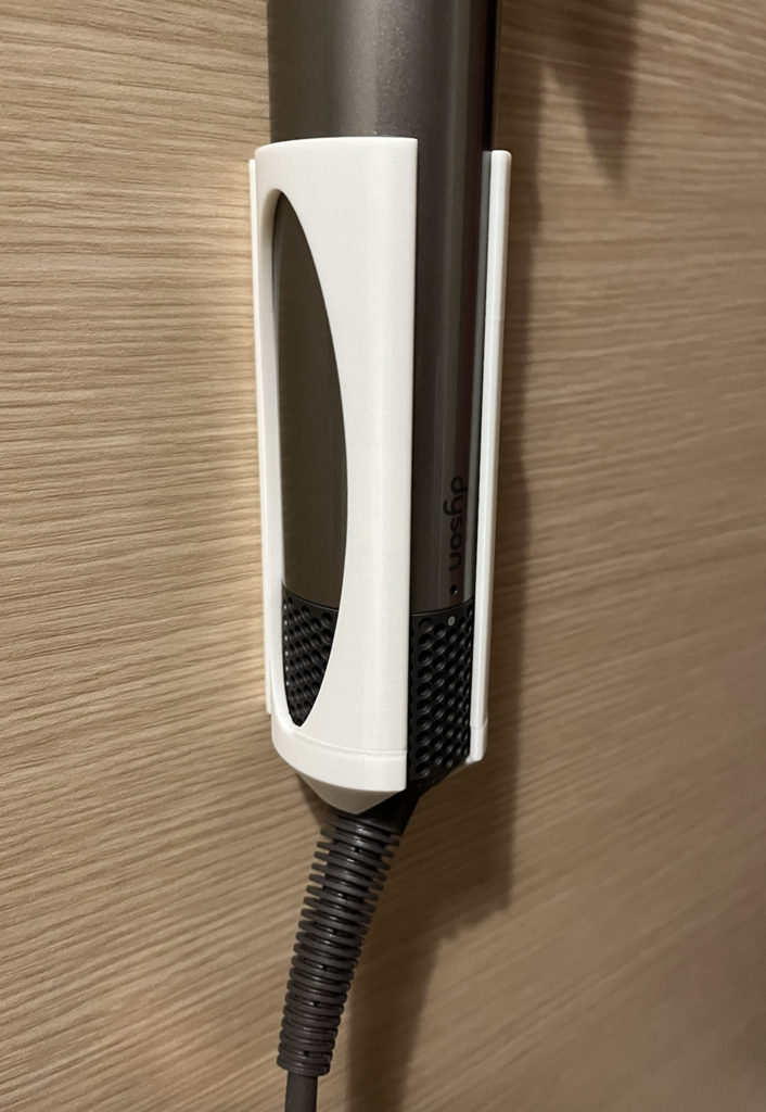 Seinäteline Dyson Airwrapille kaksipuolisella teipillä